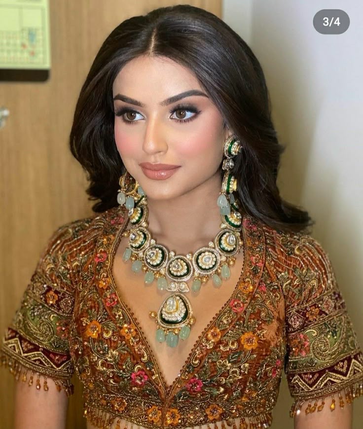 Bridal look with warm bronze eyes and emerald green earrings