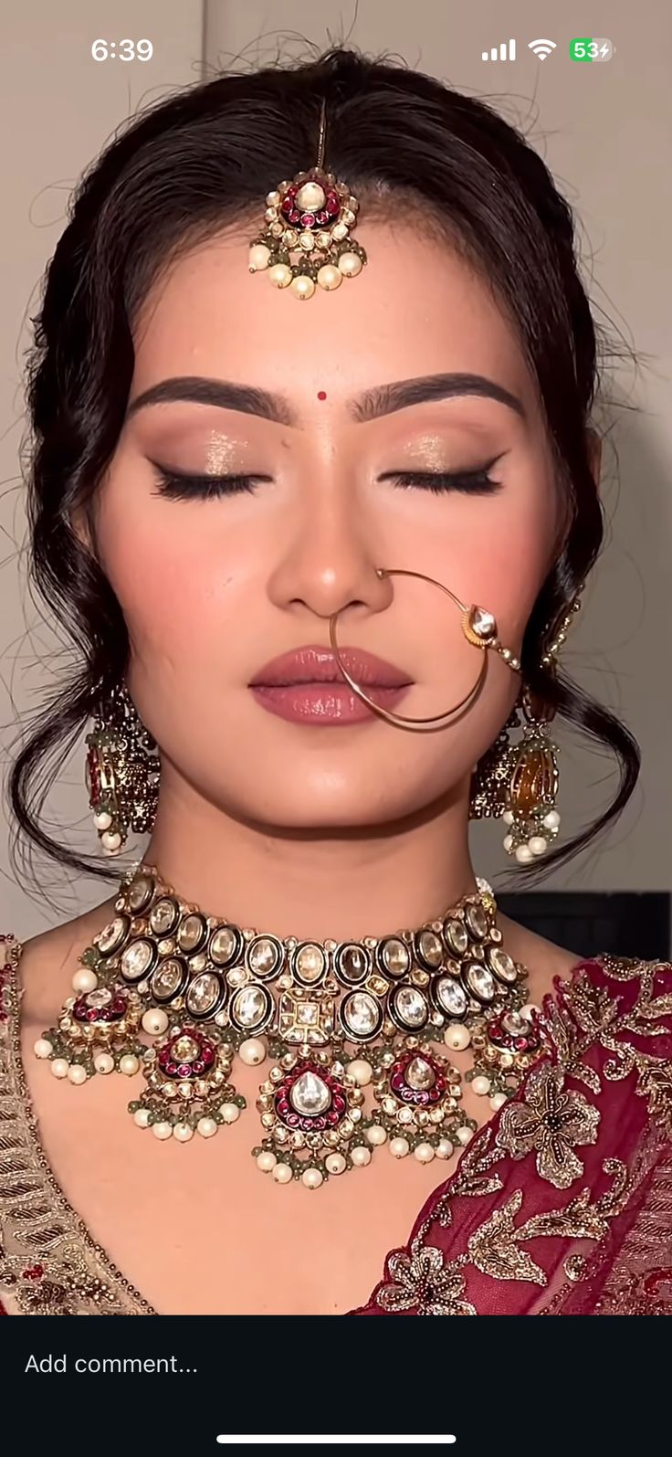Gold flecked eyeshadow detail with a circular nath
