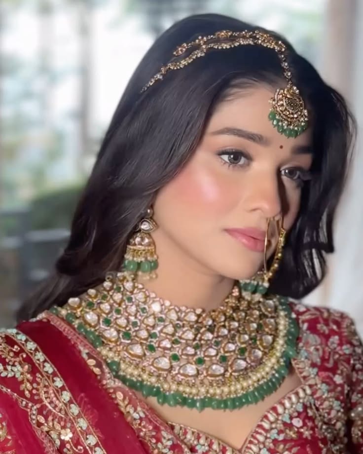 Bride wearing traditional bridal makeup with gold jewellery